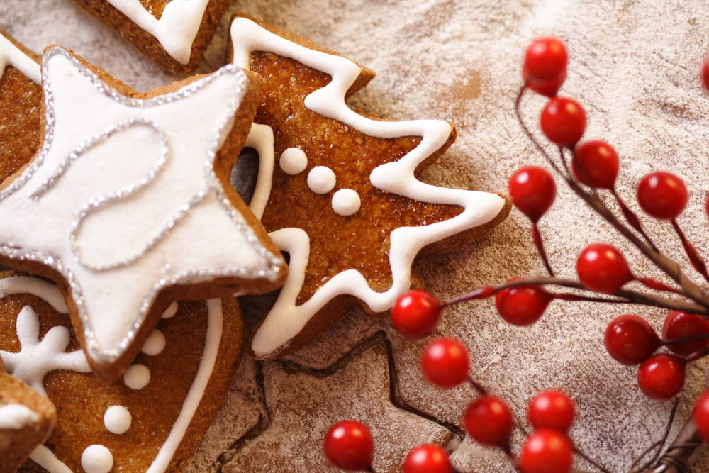 A Christmas biscuit on a table with berries around