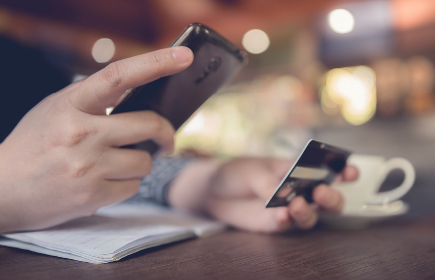 A person entering their card details onto a mobile device