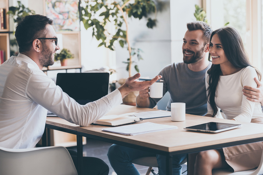 Financial adviser talking to a man and woman
