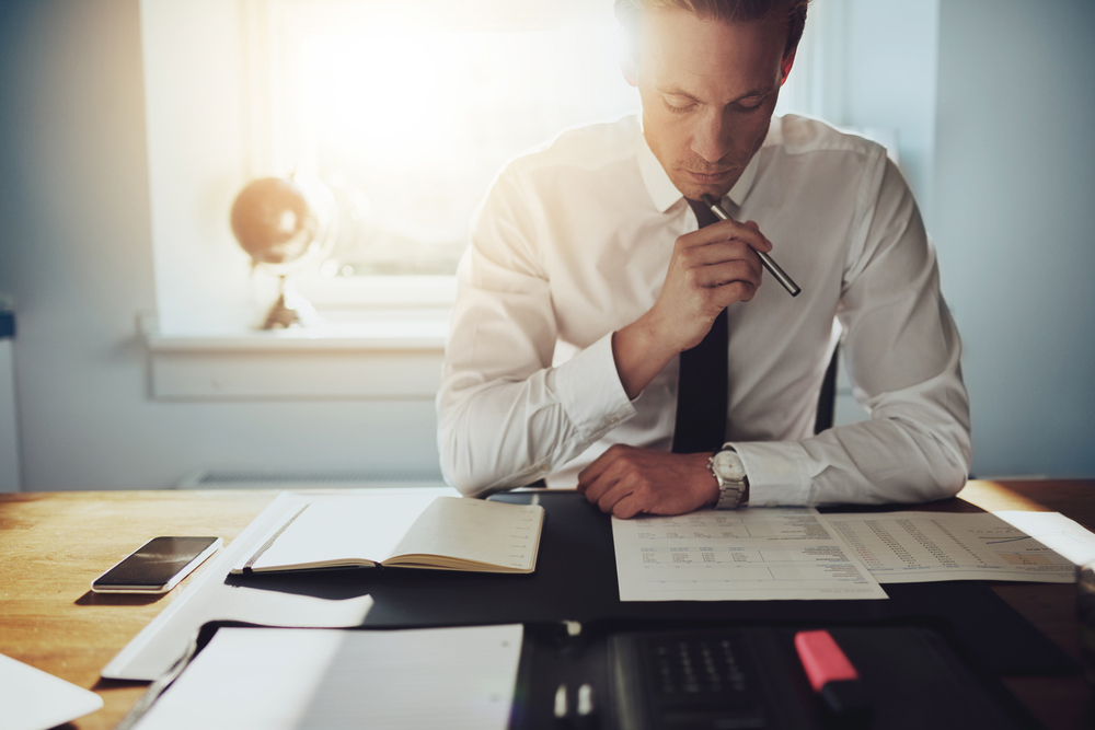 man looking at paper work