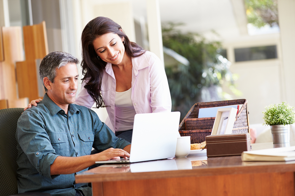 Man and woman looking at something on the laptop screen