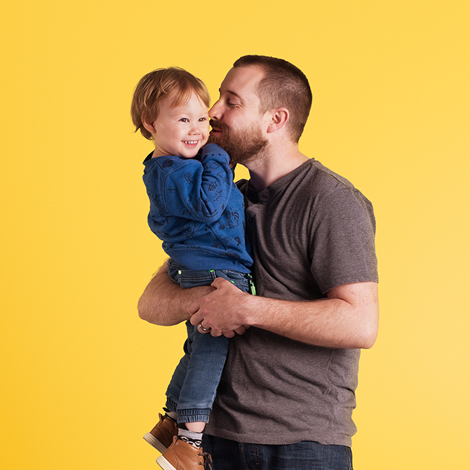 junior-isa-man-and-child-yellow Man with child on yellow background