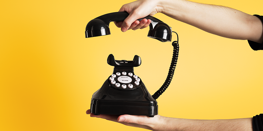 A telephone against a yellow background