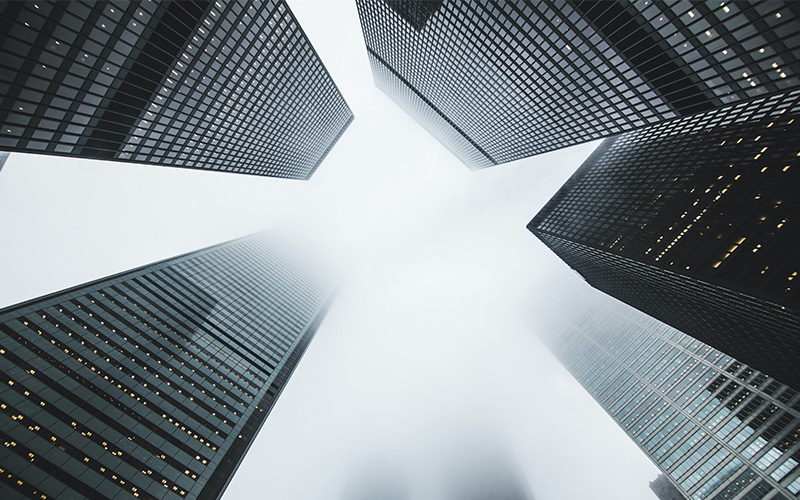 A worm's-eye view of several towering skyscrapers.