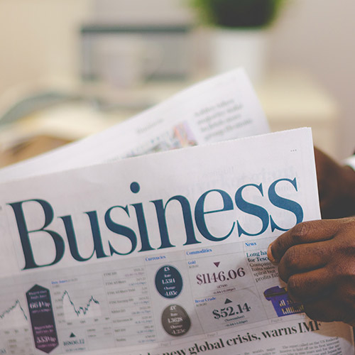 how-much-are-adviser-fees-500x500 Somebody reading a business newspaper.