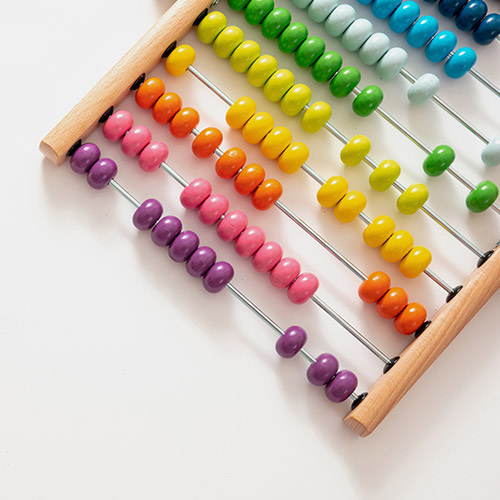 how-much-equity-can-i-release-from-my-home-500x500 A wooden abacus with multicoloured beads, sitting on a white background.