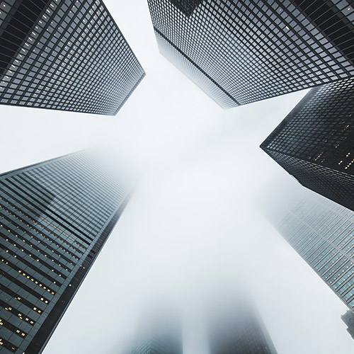 how-to-find-a-financial-adviser-500x500 A worm's-eye view of several towering skyscrapers.