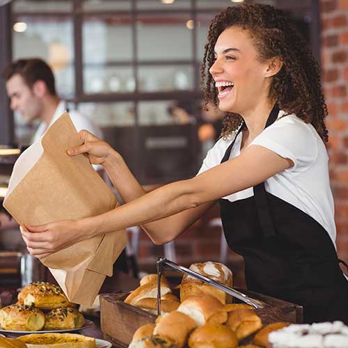 A young lady serving food at a coffee shop