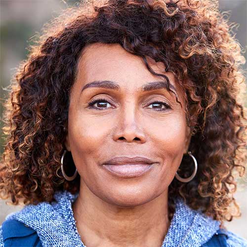 help-support-financial-abuse-500x500 A middle-aged woman smiling.