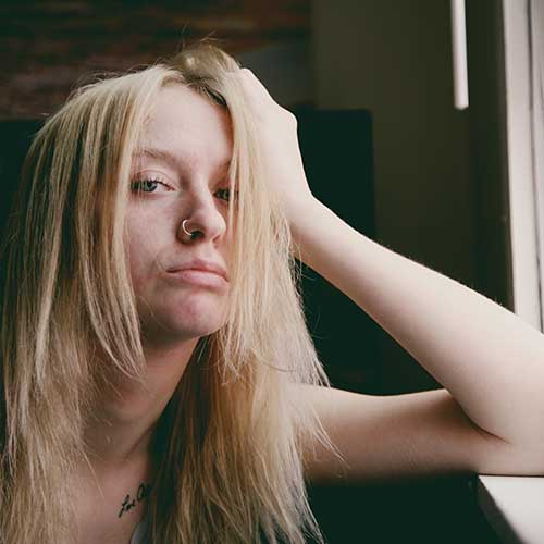pandemic-pocket-money-500x500 A fed-up looking teenage girl, resting an elbow on a window