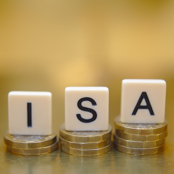 ISA spelt out with scrabble tiles on stacks of coins