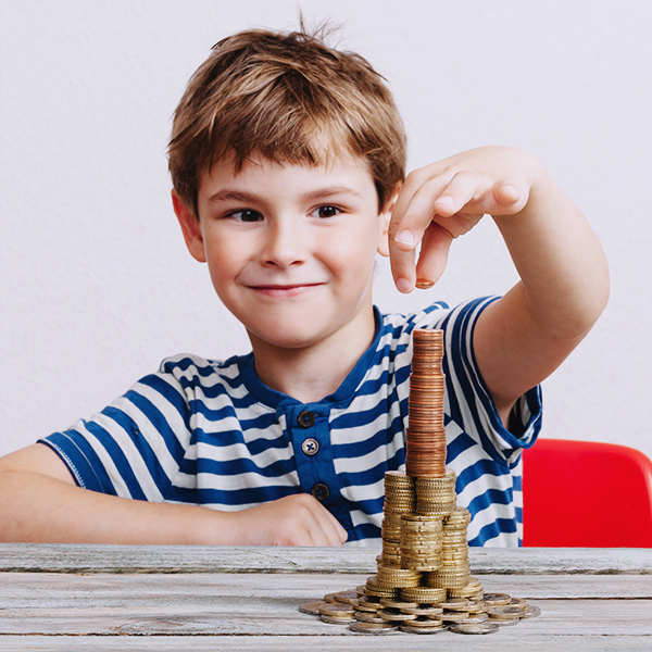 Young boy stacking money