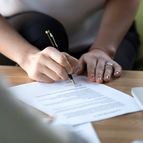 Stock_probate_sign_Will_500x500 Person signing a form