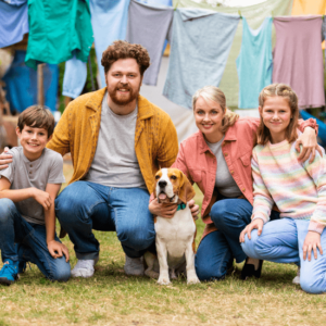 Family smiling for the camera with a beagle dog
