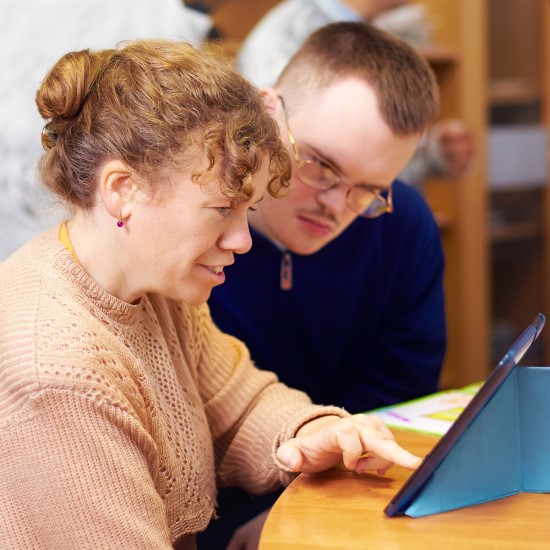Two friends using an iPad