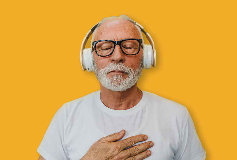 Man with his eyes shut listening to headphones