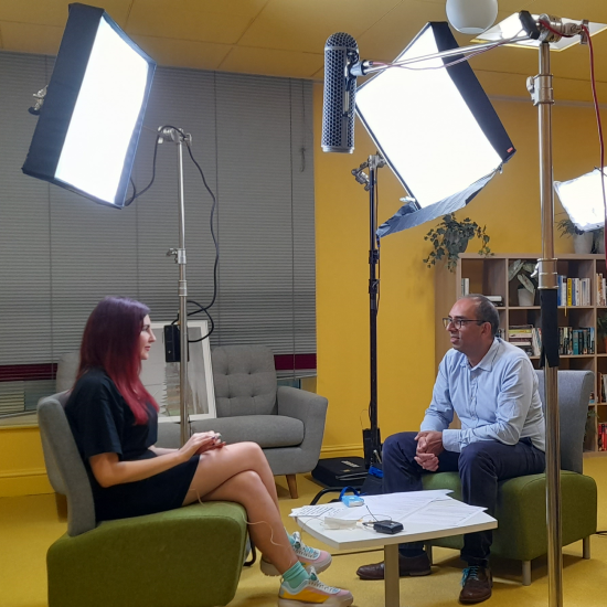 Helen Kimber and Altaf Kassam being filmed talking at the OneFamily office