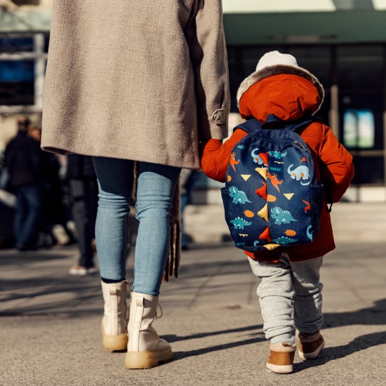 Child being walked into a nursery by a parent