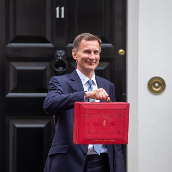 Chancellor of the Exchequer, Jeremy Hunt, holding up the red budget box