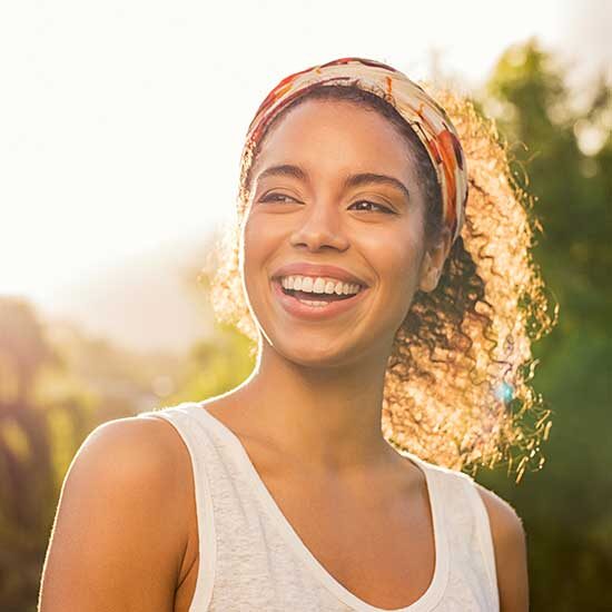A young woman smiling in the sunset