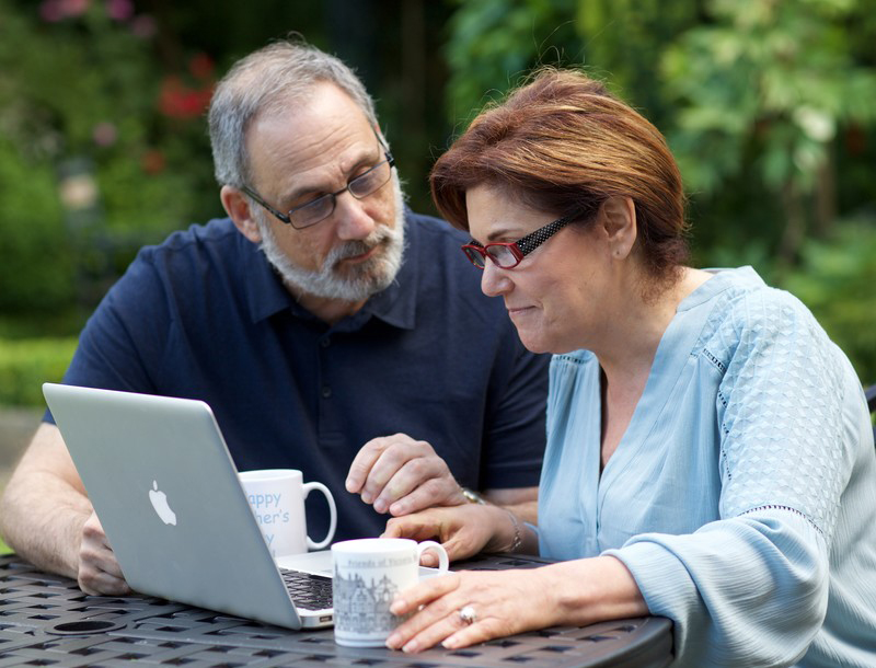 Married couple looking at a laptop