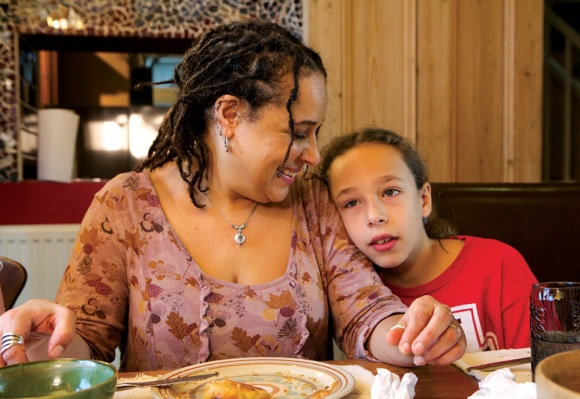 will-writing A mother and daughter cuddle at the dinner table