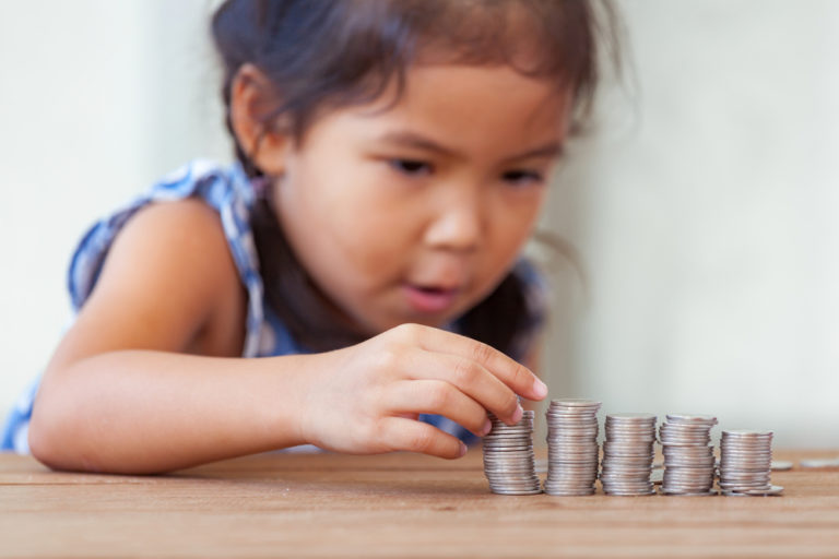Girl looking at coins