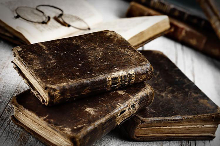 A close-up of some old, well-weathered books.