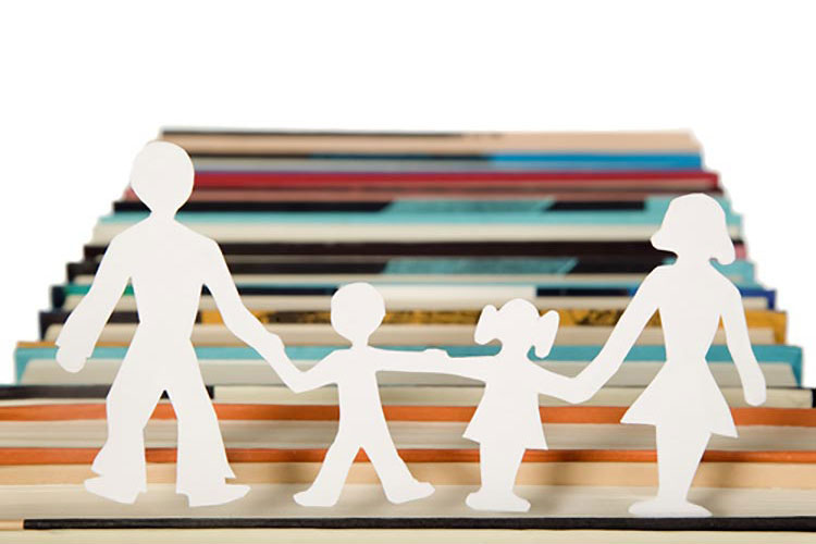 Cut-out paper figures walking along the top of some files.