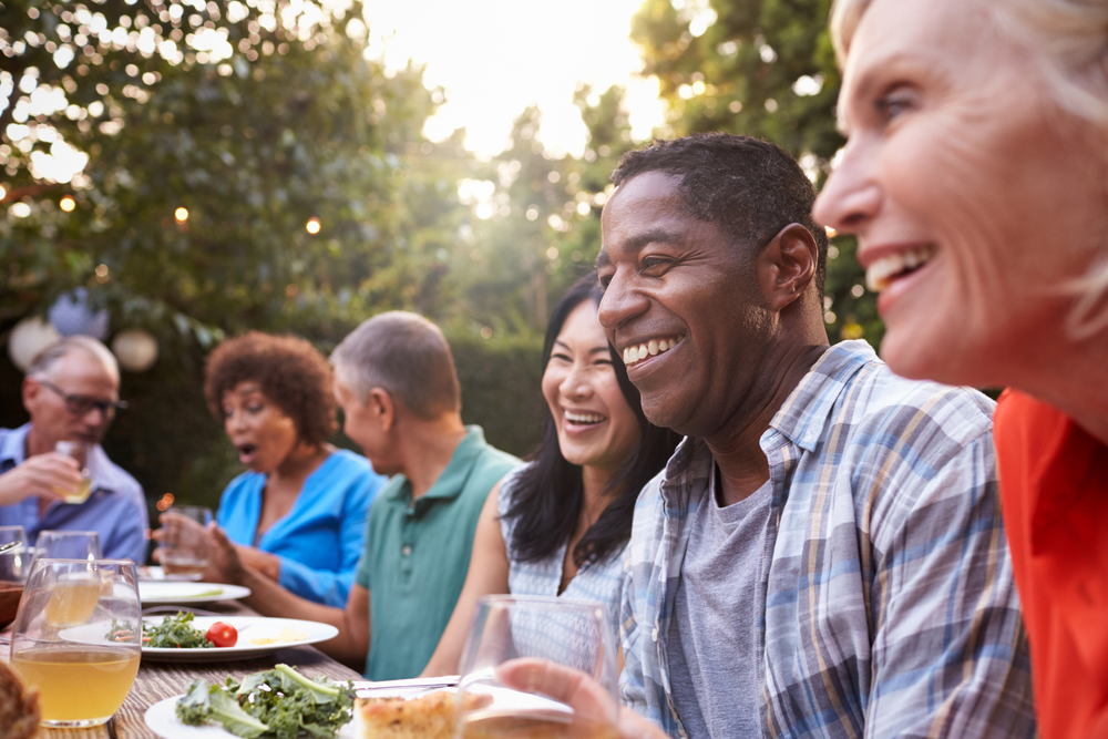 Group of mature friends dining outside