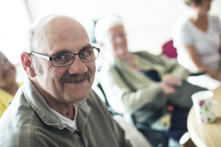 Older man with spectacles and a moustache.